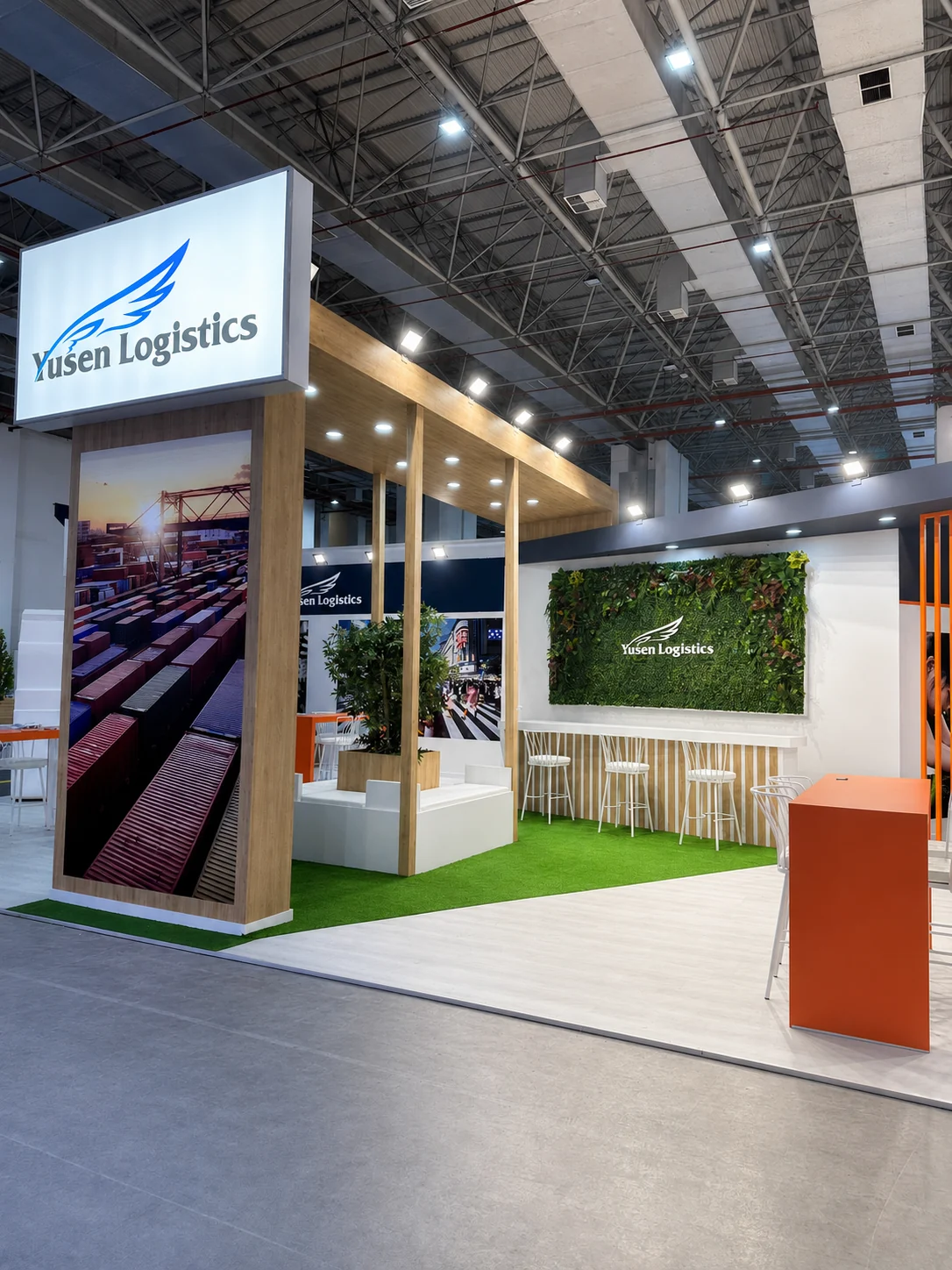 Corner view of the Yusen Logistics exhibition stand with illuminated signage and green hospitality area at Logistech İzmir 2023